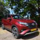 A red color Toyota Rush