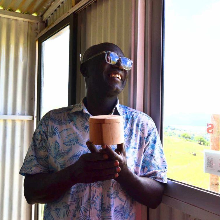 A portrait of the owner, Mr. Hortense holding a wooden jewelry box