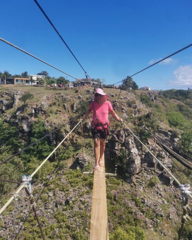 woman walking on RodrigAventure suspension bridge