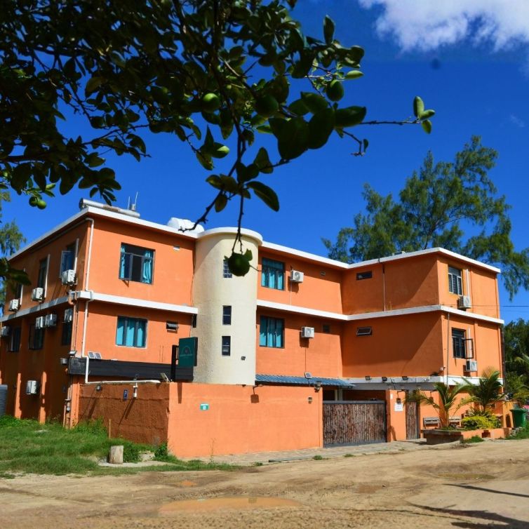 Gravier Holidays an orange-terracotta building perfectly located near Gravier beach